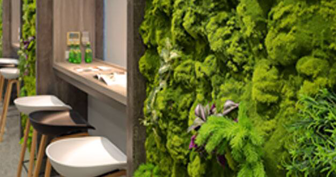 Cafe area with high chairs and Moss wall decor